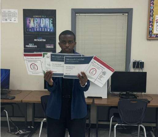 Student proudly holding earned industry certifications